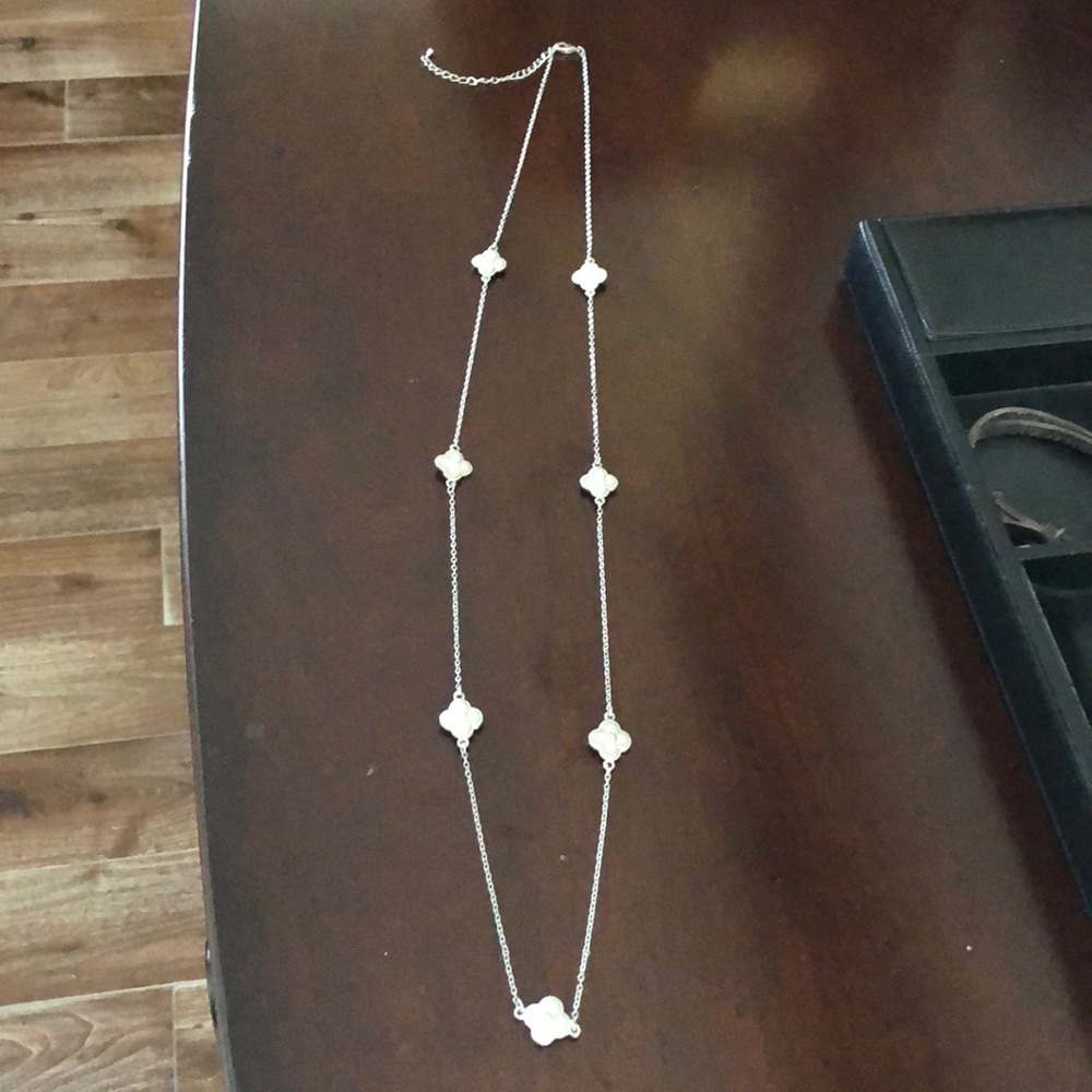 Silver tone long necklace with spaced flowers